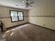 Cozy bedroom with a ceiling fan, large window, and wallpaper accent, ready for personalization at 404 Windsor Way, Peachtree City, GA 30269