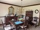 Formal dining room with a large wooden table, ornate chandelier, and classic decor at 404 Windsor Way, Peachtree City, GA 30269