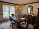 Formal dining room featuring a chandelier, large mirror, and a carpeted floor at 404 Windsor Way, Peachtree City, GA 30269