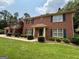 Classic brick home with well-maintained landscaping, blue shutters, and a welcoming front entrance at 404 Windsor Way, Peachtree City, GA 30269