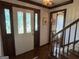 Classic foyer featuring wood flooring, a decorative glass door, and a staircase with wooden banister at 404 Windsor Way, Peachtree City, GA 30269