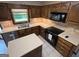 This kitchen features wooden cabinetry, an island with quartz countertops, and tile floors at 404 Windsor Way, Peachtree City, GA 30269