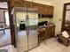 Spacious kitchen boasts stainless steel appliances, wooden cabinets, and tile floors at 404 Windsor Way, Peachtree City, GA 30269
