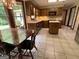 This kitchen offers ample wooden cabinetry, tile backsplash, and an island with tile floors at 404 Windsor Way, Peachtree City, GA 30269