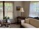 Bright sitting room featuring refined furniture, a table lamp, and natural light filtering through the window at 404 Windsor Way, Peachtree City, GA 30269