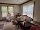 Elegant living room featuring vintage furniture, a patterned rug, and natural light from the windows at 404 Windsor Way, Peachtree City, GA 30269