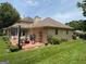 Spacious brick patio with outdoor seating, grill, and lush green lawn, great for outdoor gatherings at 404 Windsor Way, Peachtree City, GA 30269