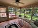 Cozy sunroom with tiled floors and multiple windows overlooking the landscaped backyard and patio at 404 Windsor Way, Peachtree City, GA 30269