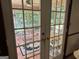 Bright sunroom featuring tiled floors, multiple windows, and views of the lush outdoor space at 404 Windsor Way, Peachtree City, GA 30269
