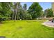 Spacious backyard with a well-kept lawn and a storage shed surrounded by mature trees at 1981 Shalimar Ne Dr, Atlanta, GA 30345