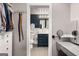 En suite bathroom featuring blue vanity, dual mirrors, next to walk in closet with storage at 1981 Shalimar Ne Dr, Atlanta, GA 30345