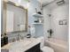 Clean bathroom featuring subway tile in shower, storage shelves and a marble vanity at 1981 Shalimar Ne Dr, Atlanta, GA 30345