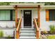 Inviting front entrance with painted steps, stylish wood supports, modern door, and charming stone landscaping at 1981 Shalimar Ne Dr, Atlanta, GA 30345