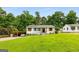 Landscaped front yard of a charming one-story home with a carport and natural wood accents on windows and front door at 1981 Shalimar Ne Dr, Atlanta, GA 30345
