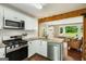 Bright kitchen featuring stainless steel appliances, white cabinets, and an open concept to the living room at 1981 Shalimar Ne Dr, Atlanta, GA 30345