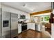 Modern kitchen with stainless steel appliances, white cabinets, dark hardwood floors, and wood ceiling accents at 1981 Shalimar Ne Dr, Atlanta, GA 30345