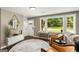 Cozy living room with a front entrance view, hardwood floors, large windows, and stylish décor at 1981 Shalimar Ne Dr, Atlanta, GA 30345
