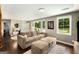 Bright living room with hardwood floors, neutral-toned sofa and furnishings, and large windows at 1981 Shalimar Ne Dr, Atlanta, GA 30345