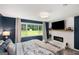 Bright main bedroom features fireplace, and a large window with a view of the backyard at 1981 Shalimar Ne Dr, Atlanta, GA 30345