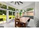 Charming sunroom with a dining table, built-in banquette seating, and views of the landscaped backyard at 1981 Shalimar Ne Dr, Atlanta, GA 30345