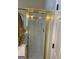 Bathroom featuring a glass enclosed shower with gold trim and white tiled walls at 3955 Sweetwater Pkwy, Ellenwood, GA 30294