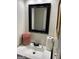 This bathroom has a black framed mirror, a white sink, and a towel at 3955 Sweetwater Pkwy, Ellenwood, GA 30294