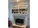 Cozy fireplace featuring white mantle and shelving with decorative tile surround and hearth at 3955 Sweetwater Pkwy, Ellenwood, GA 30294