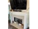 Bright living area showcasing fireplace, TV, plush seating, decorative rug and stylish floor lamp at 3955 Sweetwater Pkwy, Ellenwood, GA 30294