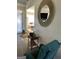 Open-concept living room with round decorative mirror with hallway and furniture at 3955 Sweetwater Pkwy, Ellenwood, GA 30294
