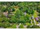 Aerial view of a home nestled among lush trees, showcasing the surrounding landscape and neighborhood at 610 Lake Dr, Snellville, GA 30039