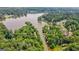 Scenic aerial view of the community's waterfront property surrounded by lush greenery and serene waters at 610 Lake Dr, Snellville, GA 30039