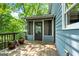 Wooden back deck with seating and green backyard views at 610 Lake Dr, Snellville, GA 30039