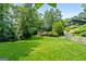 Expansive backyard featuring lush green lawn and mature trees, providing a serene and private outdoor space at 610 Lake Dr, Snellville, GA 30039