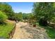 Inviting backyard featuring a stone patio, mature trees, and comfortable outdoor seating for relaxing and entertaining at 610 Lake Dr, Snellville, GA 30039