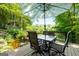Serene backyard area showcasing a deck with dining set overlooking a koi pond, creating a peaceful retreat at 610 Lake Dr, Snellville, GA 30039