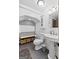 Charming bathroom with pedestal sink, toilet, overhead storage, and unique design at 610 Lake Dr, Snellville, GA 30039
