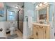 Light and airy bathroom with single vanity, decorative mirror and walk in shower at 610 Lake Dr, Snellville, GA 30039