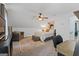 Comfortable bedroom boasts natural light, ceiling fan, and sitting area with a comfy couch at 610 Lake Dr, Snellville, GA 30039