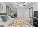 Bedroom boasts a unique geometric quilt on the bed and a comfortable lounge chair at 610 Lake Dr, Snellville, GA 30039