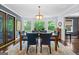 Bright dining room featuring a table with seating for six, light fixture and large windows with backyard views at 610 Lake Dr, Snellville, GA 30039