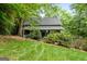 Inviting home with a cozy front porch surrounded by lush greenery and a well-maintained lawn at 610 Lake Dr, Snellville, GA 30039