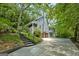 Beautiful two-story home featuring a 2-car garage, wood siding, stone chimney and stairs leading to the front porch at 610 Lake Dr, Snellville, GA 30039