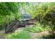 Exterior view highlighting the multi-level decks and the lush, wooded surroundings of the home at 610 Lake Dr, Snellville, GA 30039