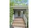 Inviting front porch with wooden steps and decorative details surrounding the front door at 610 Lake Dr, Snellville, GA 30039