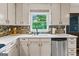 Kitchen featuring stainless steel appliances and a view to backyard at 610 Lake Dr, Snellville, GA 30039