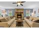 Cozy living room with hardwood floors, a stone fireplace, and comfortable seating around a central coffee table at 610 Lake Dr, Snellville, GA 30039