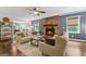 Comfortable living room featuring hardwood floors, a stone fireplace, and neutral-toned furniture at 610 Lake Dr, Snellville, GA 30039
