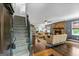 Spacious living room featuring a stone fireplace, hardwood floors, and a staircase to the upper level at 610 Lake Dr, Snellville, GA 30039
