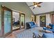 Relaxing outdoor patio featuring comfortable seating, ceiling fan, and view into dining room through sliding doors at 610 Lake Dr, Snellville, GA 30039