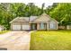 Charming single-Gathering home boasts a two-car garage and well-manicured lawn surrounded by mature trees at 345 Morning Star Dr, Temple, GA 30179